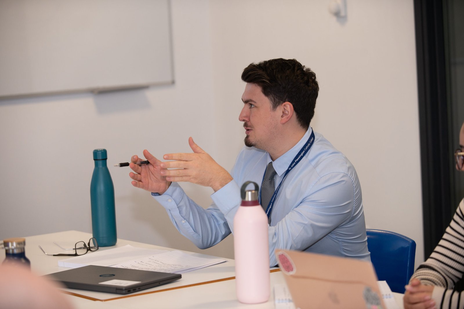 A teacher explaining ideas to secondary pupils